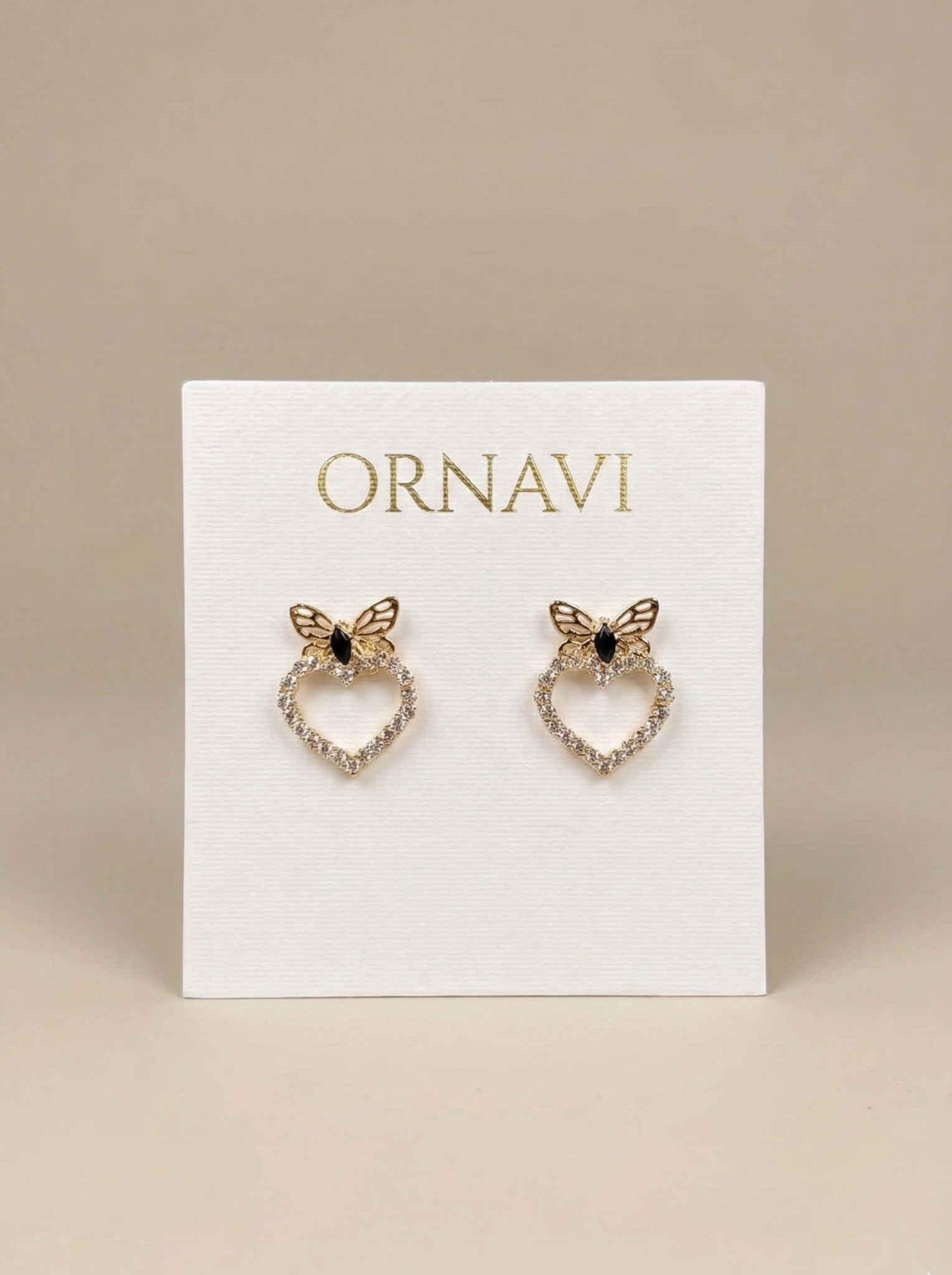 Butterfly-shaped earrings on a white card with 'ORNAVI' branding.