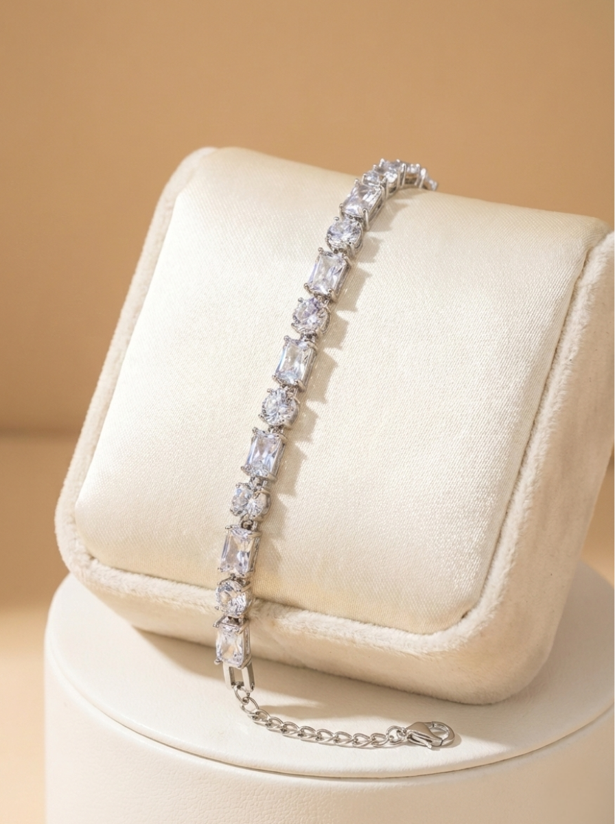 Diamond bracelet on a white cushion with a beige background