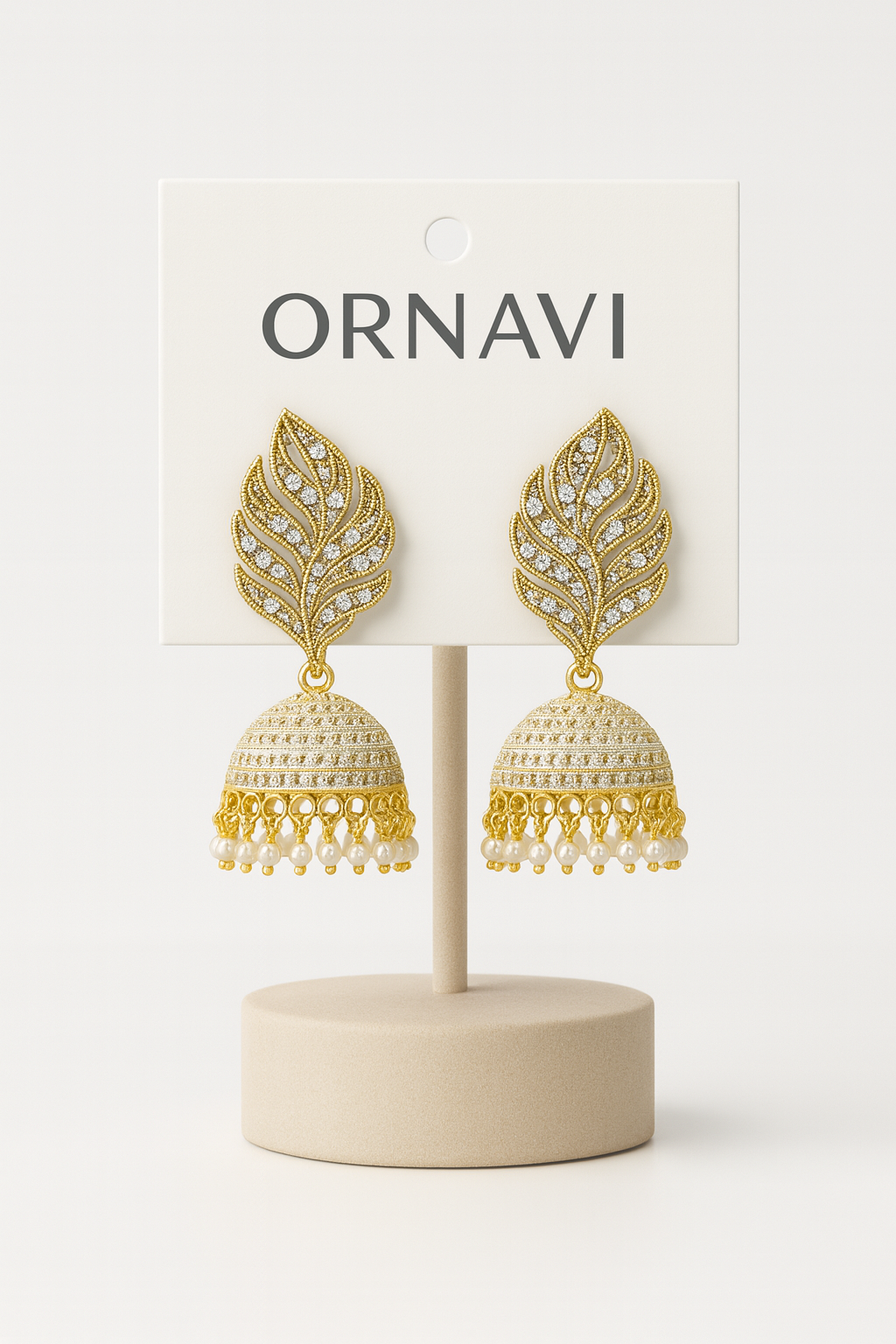 Gold leaf earrings on a display stand with 'ORNAVI'