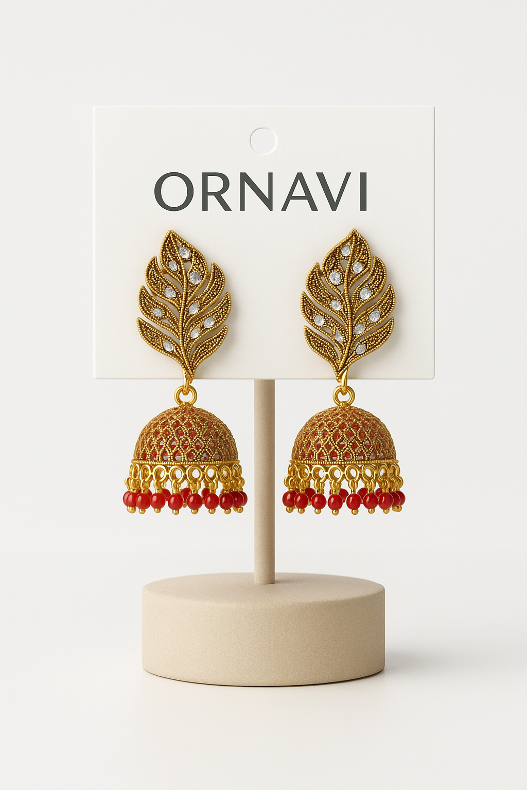 Gold leaf earrings on a display stand with 'ORNAVI' branding on a white background