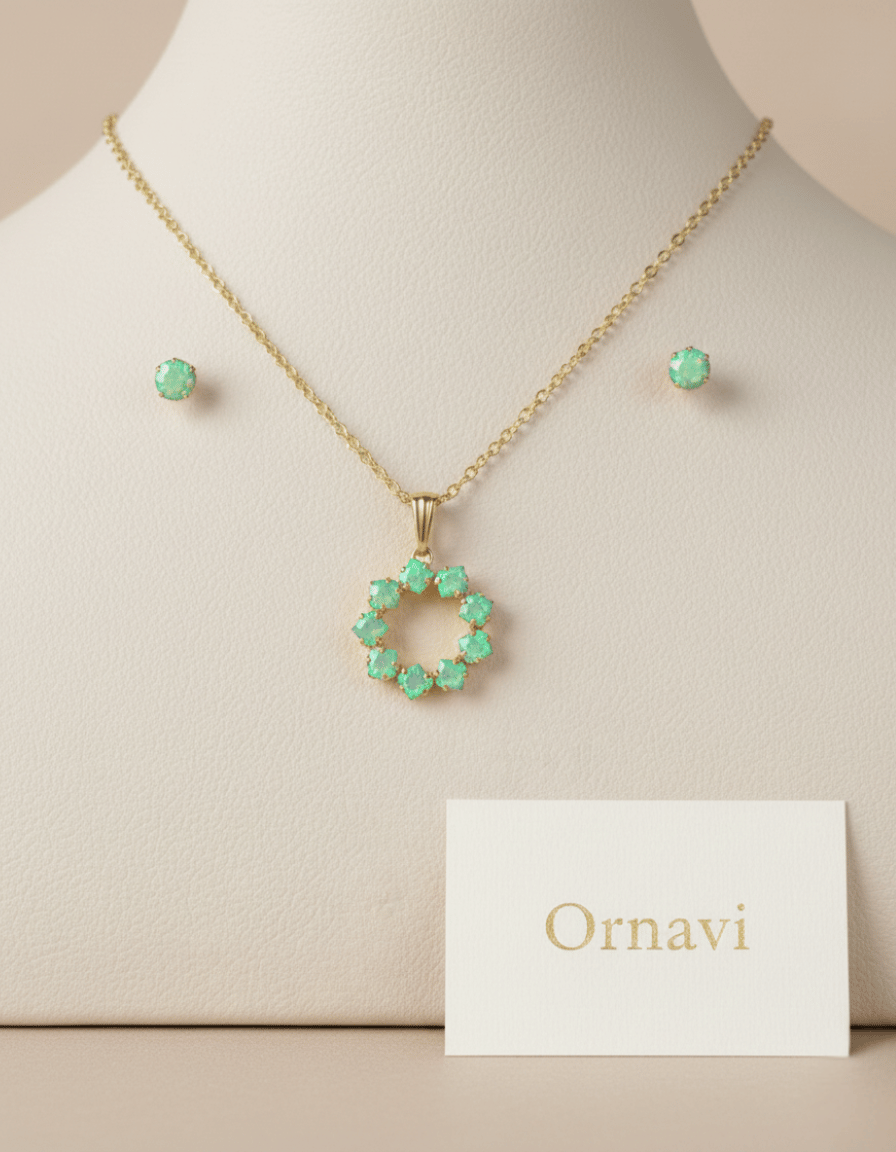 Gold necklace with green gemstones on a mannequin bust, accompanied by a 'Ornavi' card.