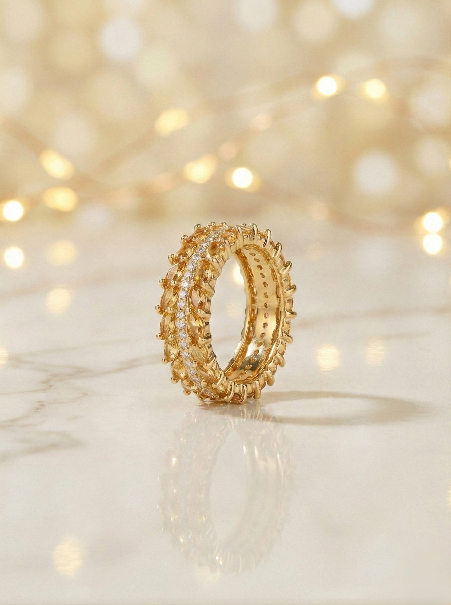 Gold ring with intricate design on a soft, blurred background