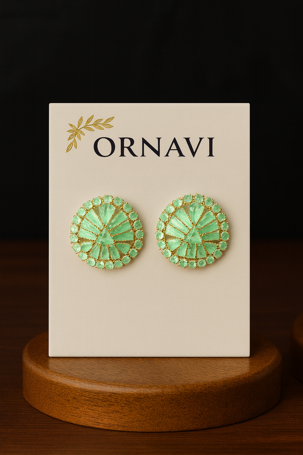 Green earrings on a 'ORNAVI' branded card with a dark background