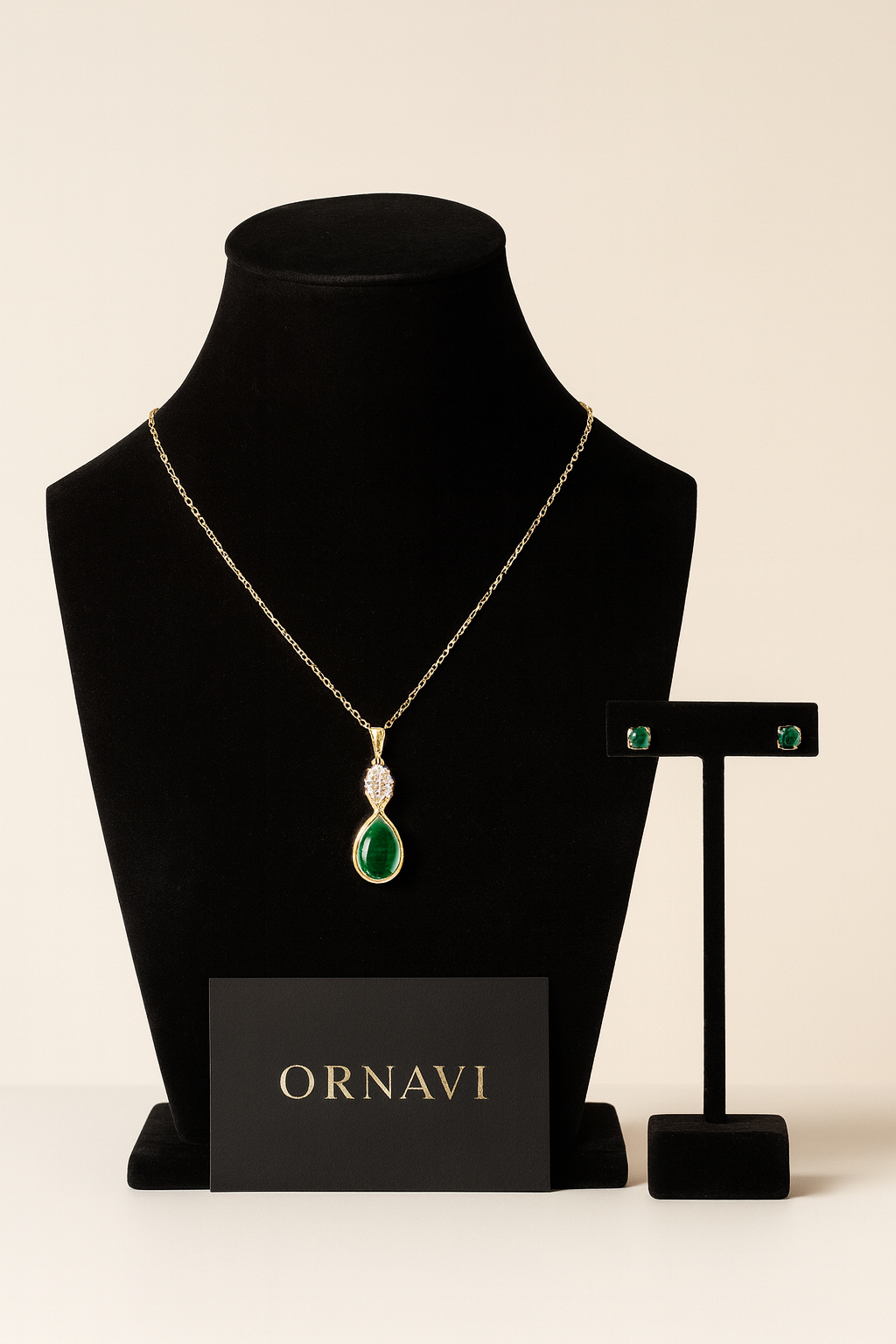 Jewelry set with necklace and earrings on a black mannequin bust, featuring the brand 'ORNAVI'.