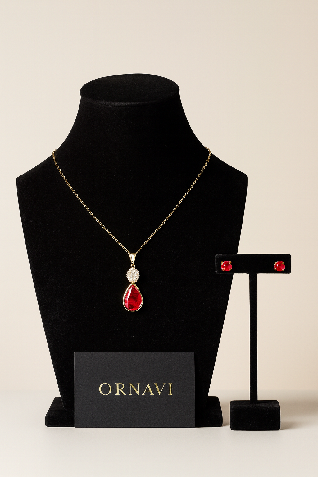Jewelry set with necklace and earrings on a black stand, featuring the brand 'ORNAVI'.