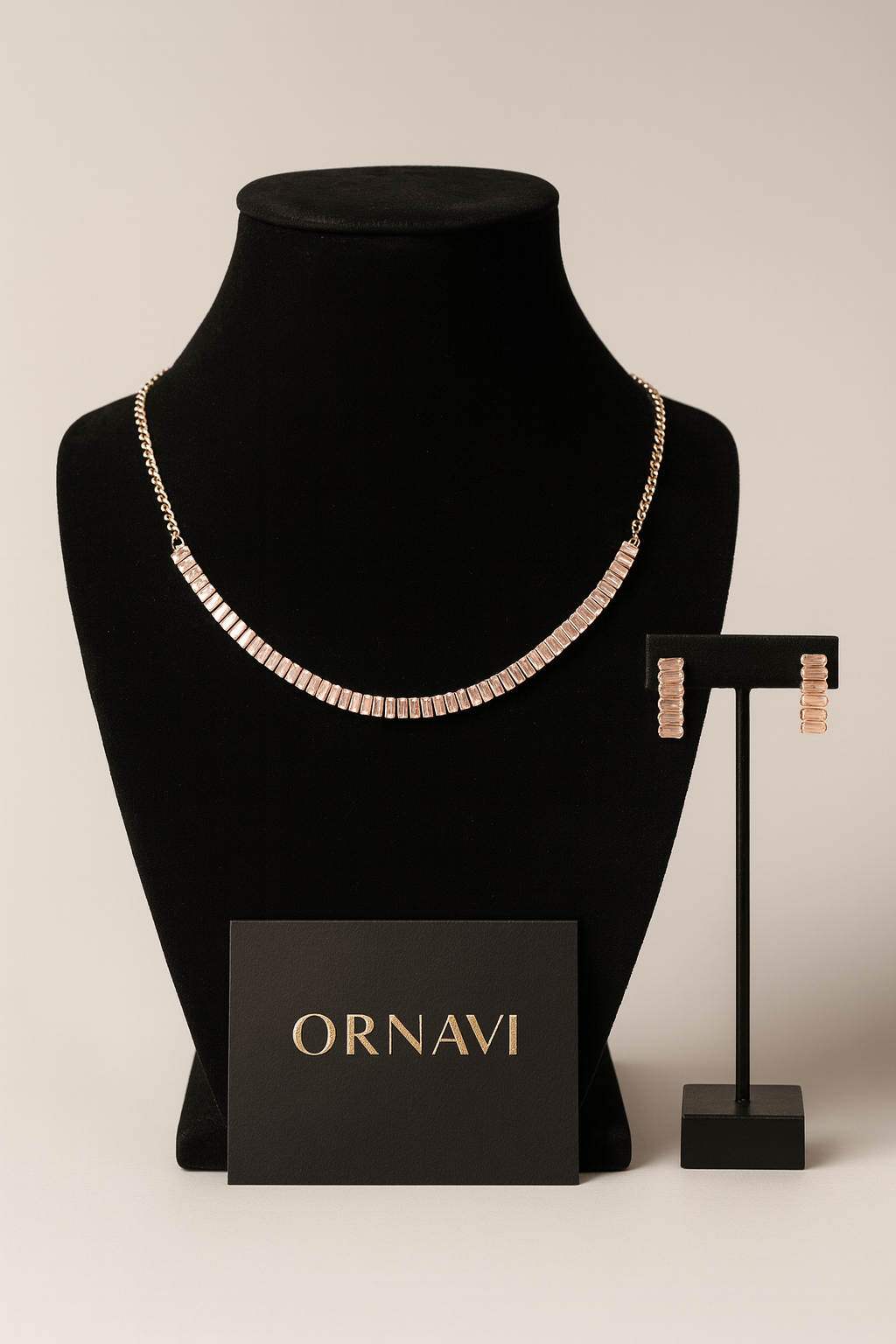 Necklace on a black mannequin bust with 'ORNAVI' card and earrings on a stand.
