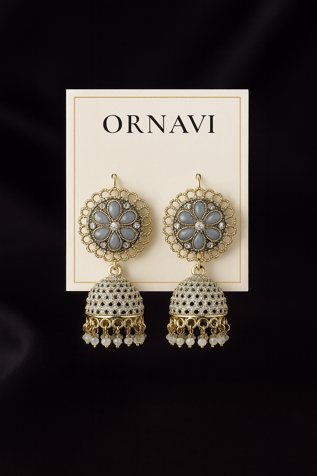 Ornate earrings on a 'ORNAVI' branded card against a dark background