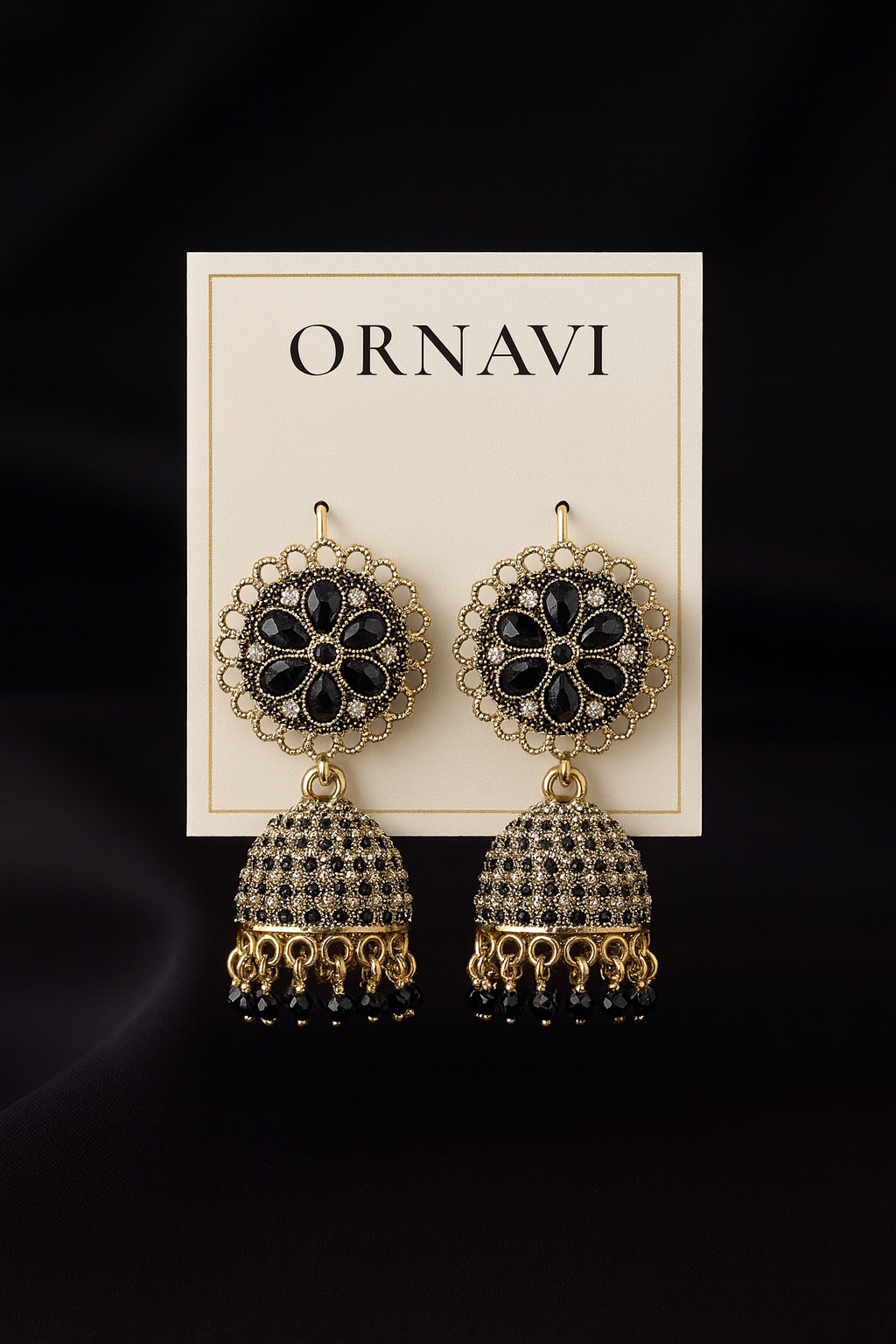 Ornate earrings on a 'ORNAVI' branded card against a black background