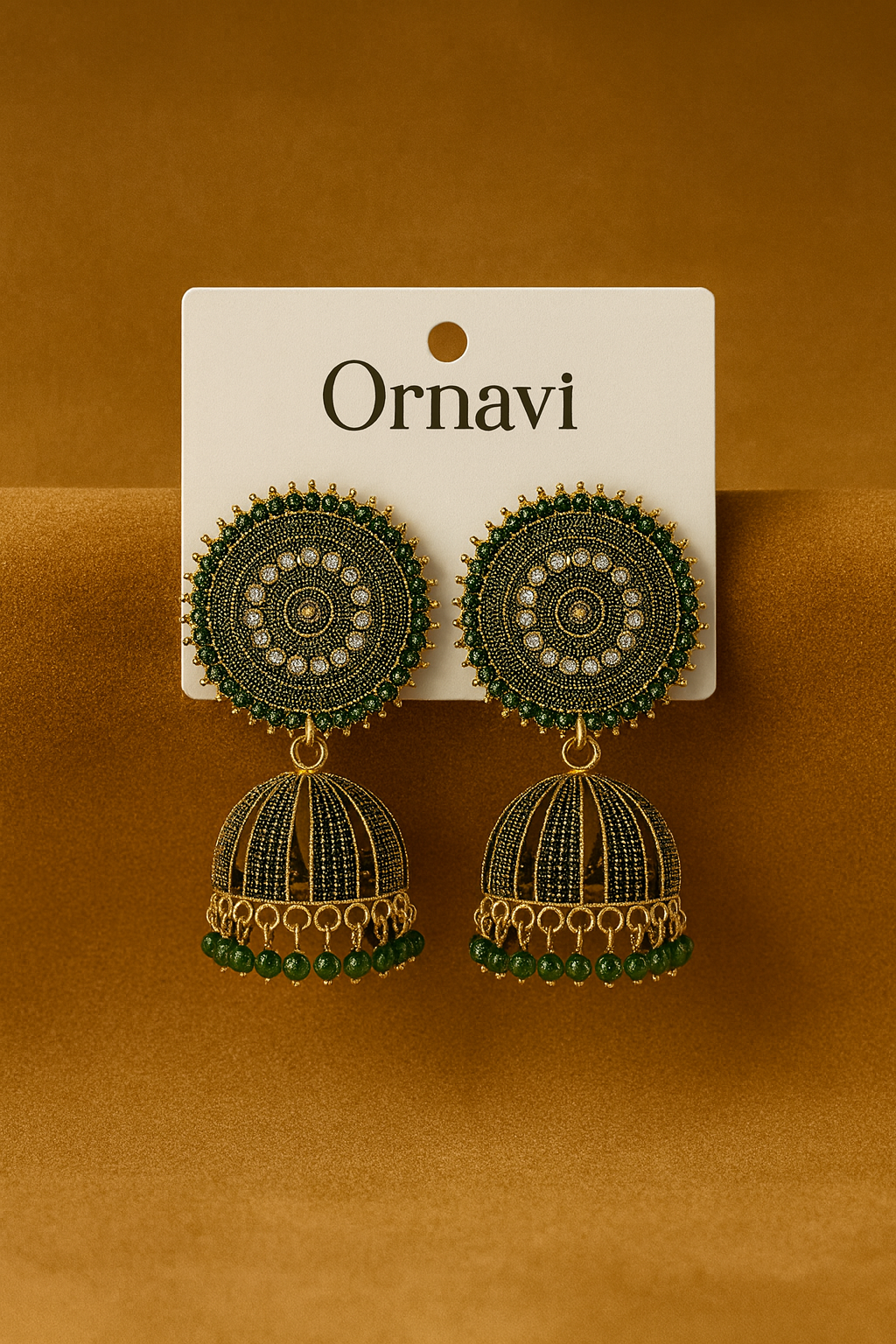 Ornate earrings on a 'Ornavi' branded card against a brown background