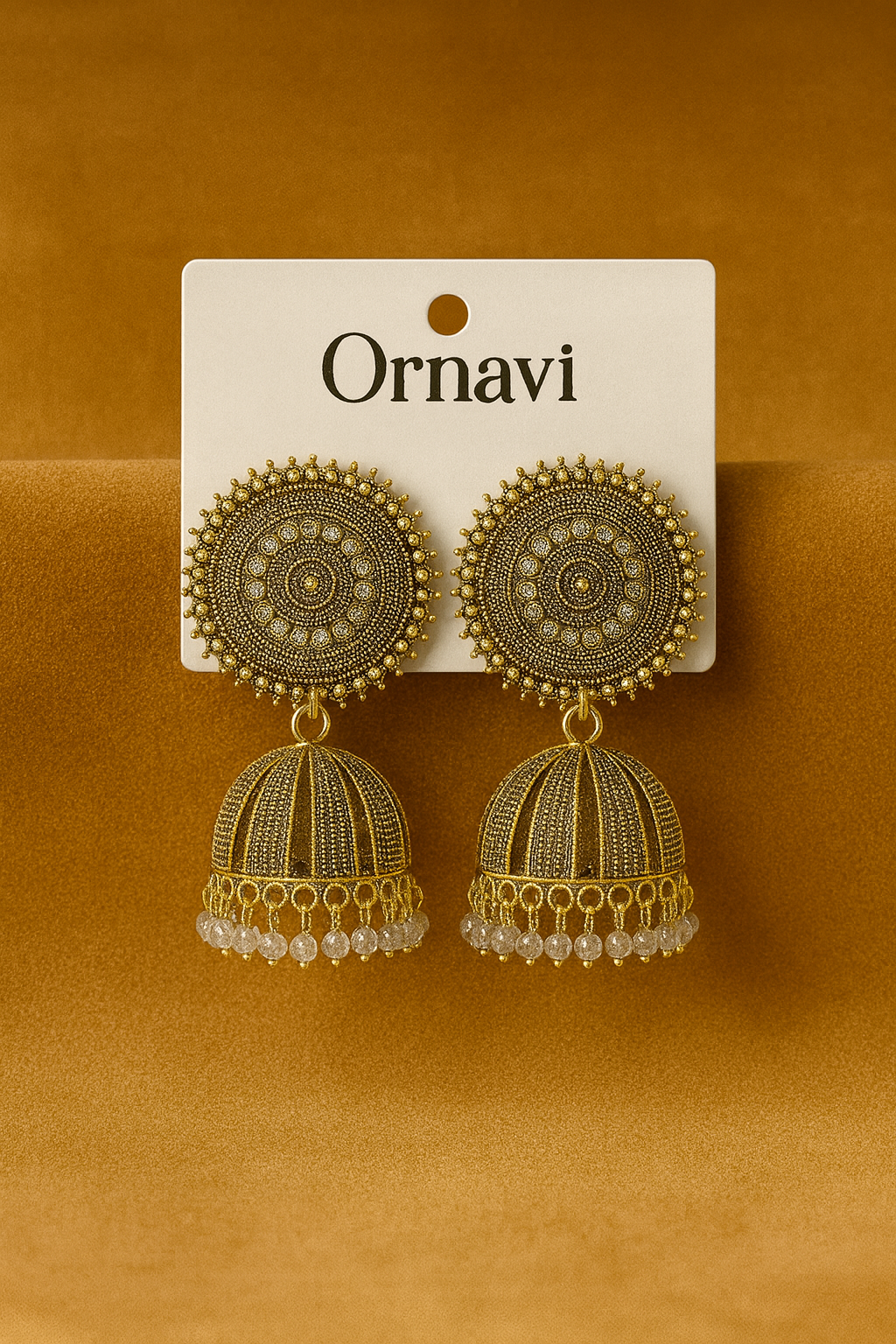 Ornate earrings on a 'Ornavi' branded card against an orange background