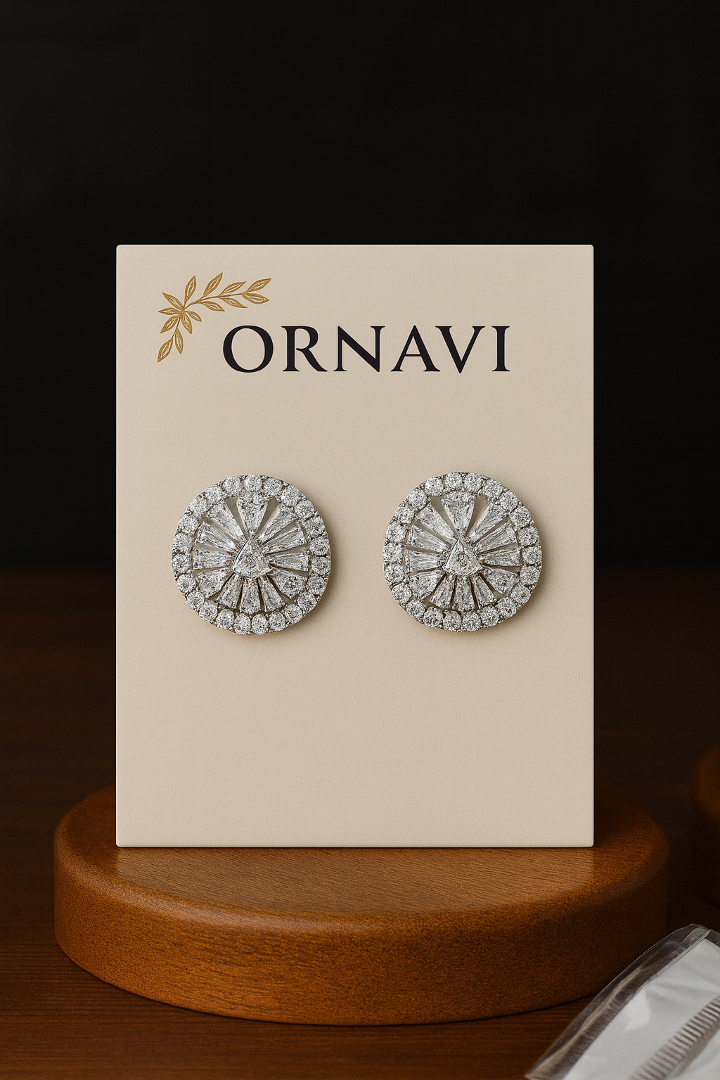 Ornavi earrings on a display card with a wooden stand