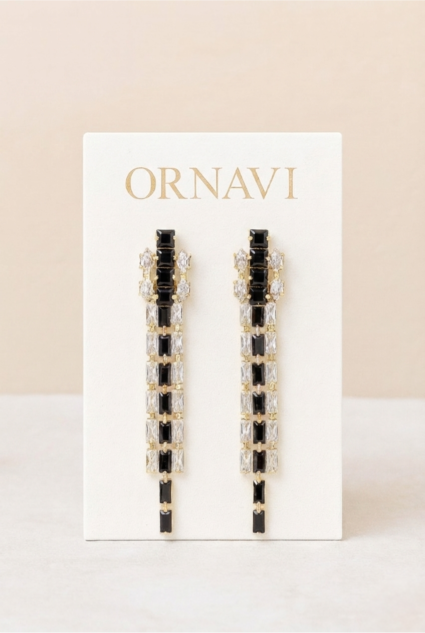 Ornavi earrings on a white card with a beige background