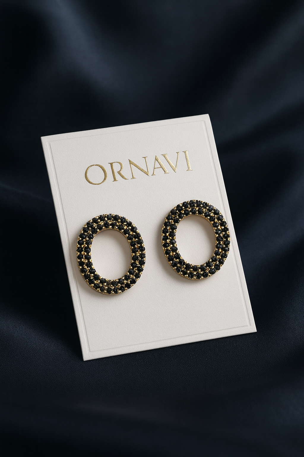 Pair of beaded earrings on a 'ORNAVI' branded card against a dark background