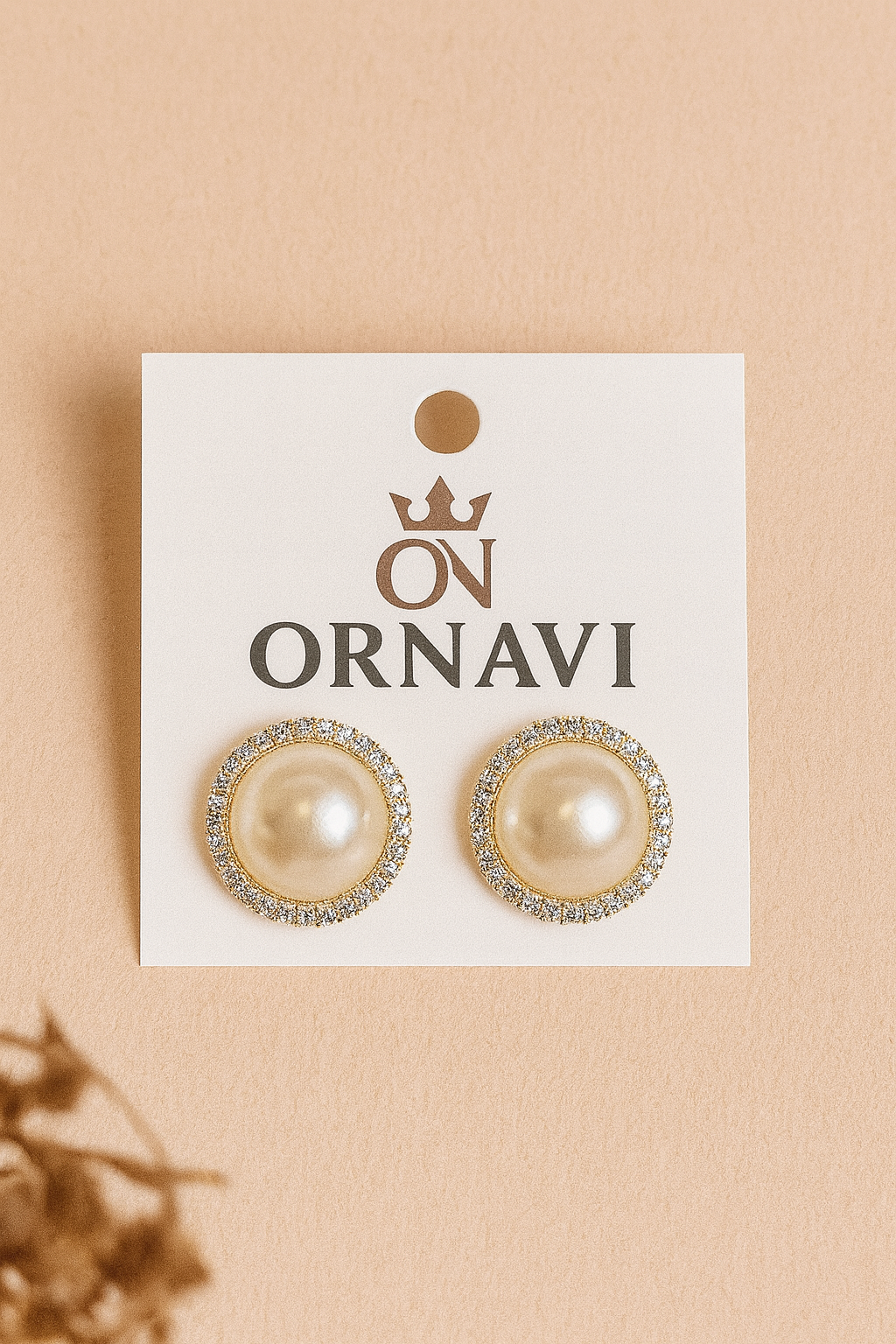 Pearl earrings on a display card with 'ORNAVI' branding on a beige background