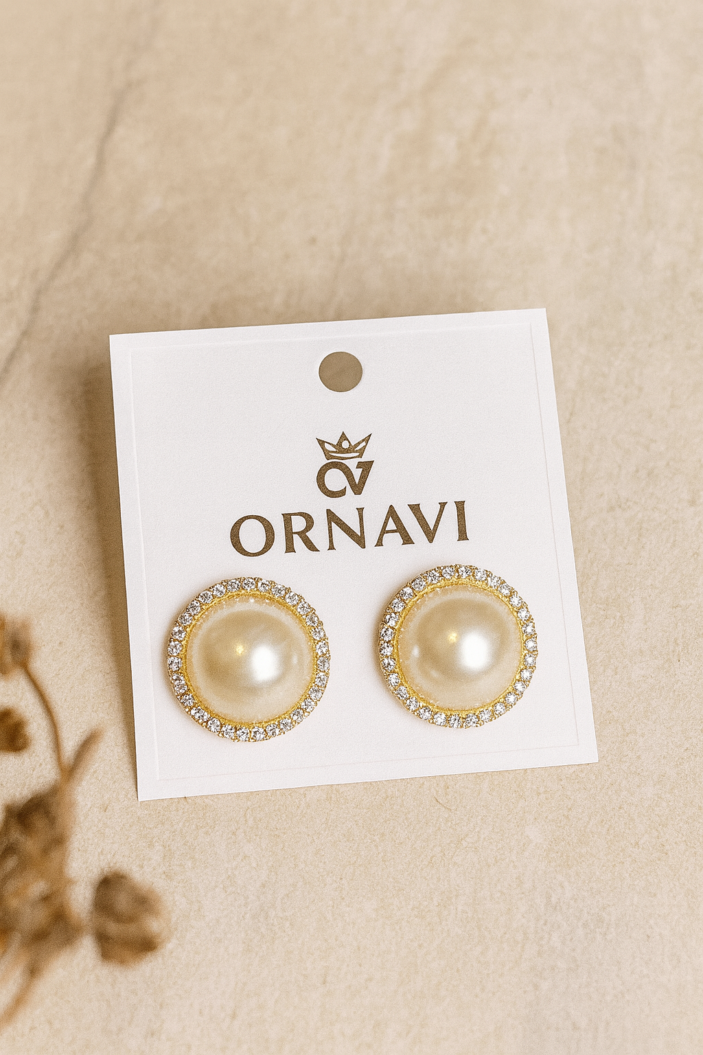 Pearl earrings on a white card with 'ORNAVI' branding on a beige background