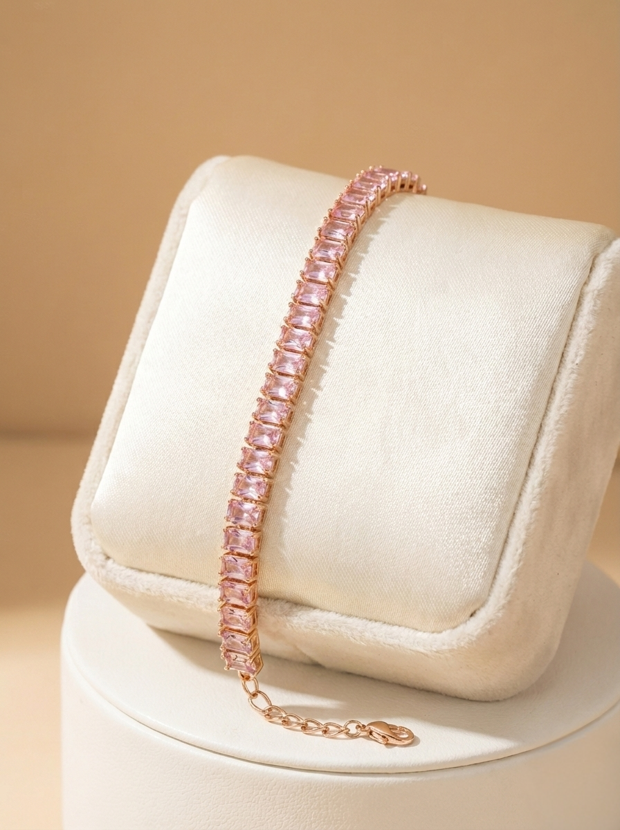 Pink beaded bracelet on a white cushion with a beige background