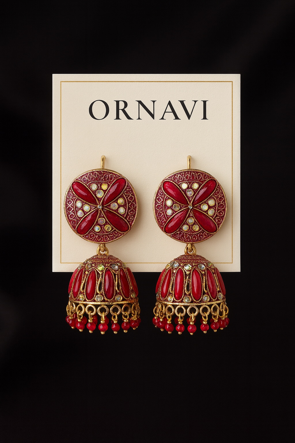 Red and gold earrings on a display card with 'Ornavi' branding against a black background