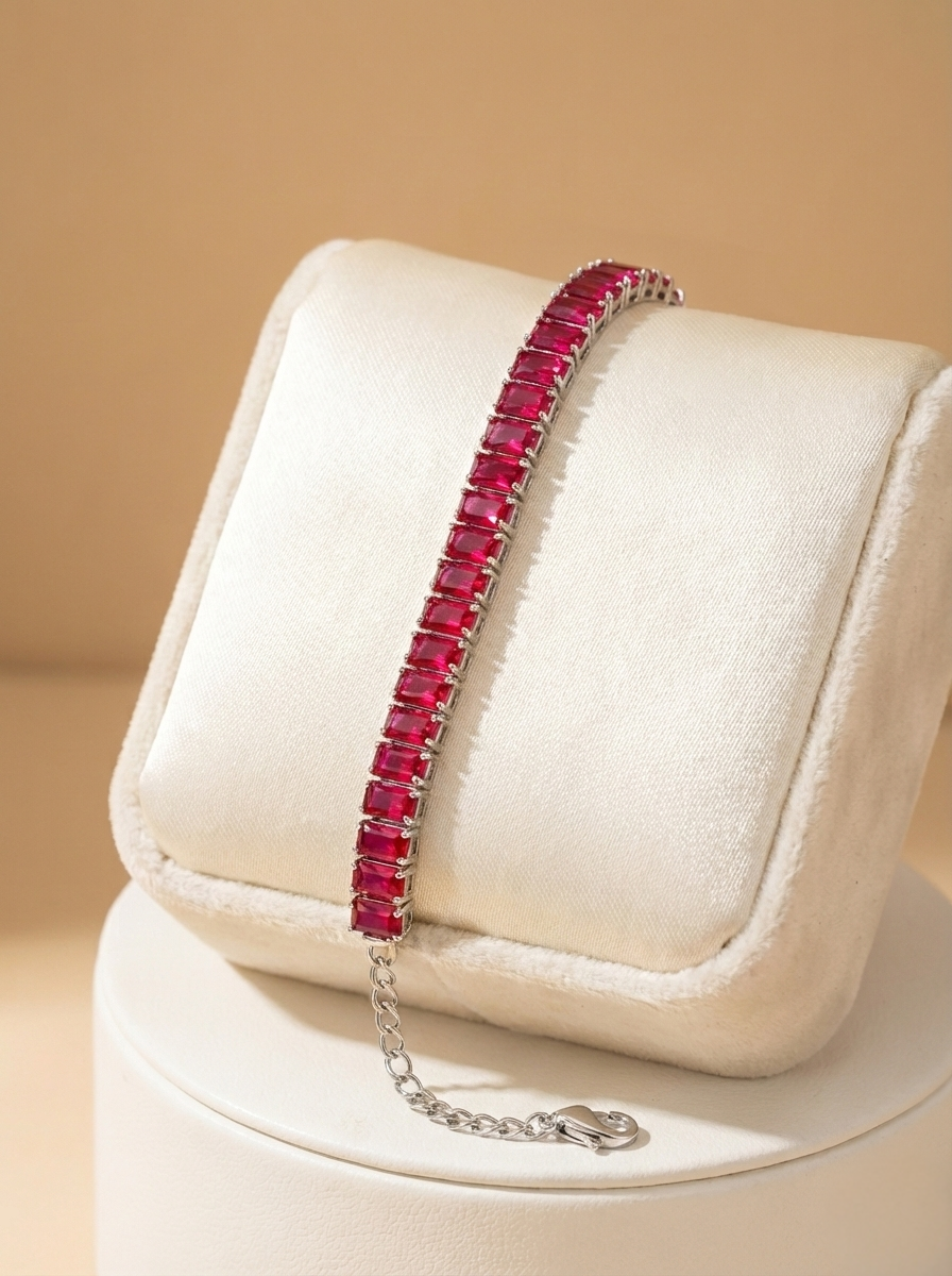 Ruby bracelet on a white cushion with a beige background